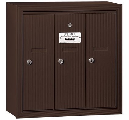 Brown wall-mounted U.S. Mailbox with three locking compartments.