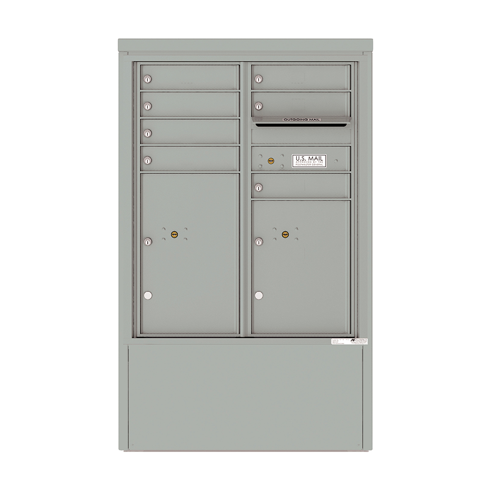 Gray metal cluster mailbox with multiple compartments and U.S. Mail label.