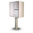 Freestanding beige metal mailbox unit with multiple compartments on a pedestal.